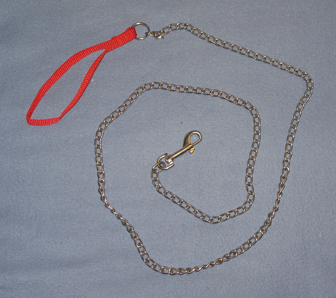 A metal chain dog leash with a red wrist loop